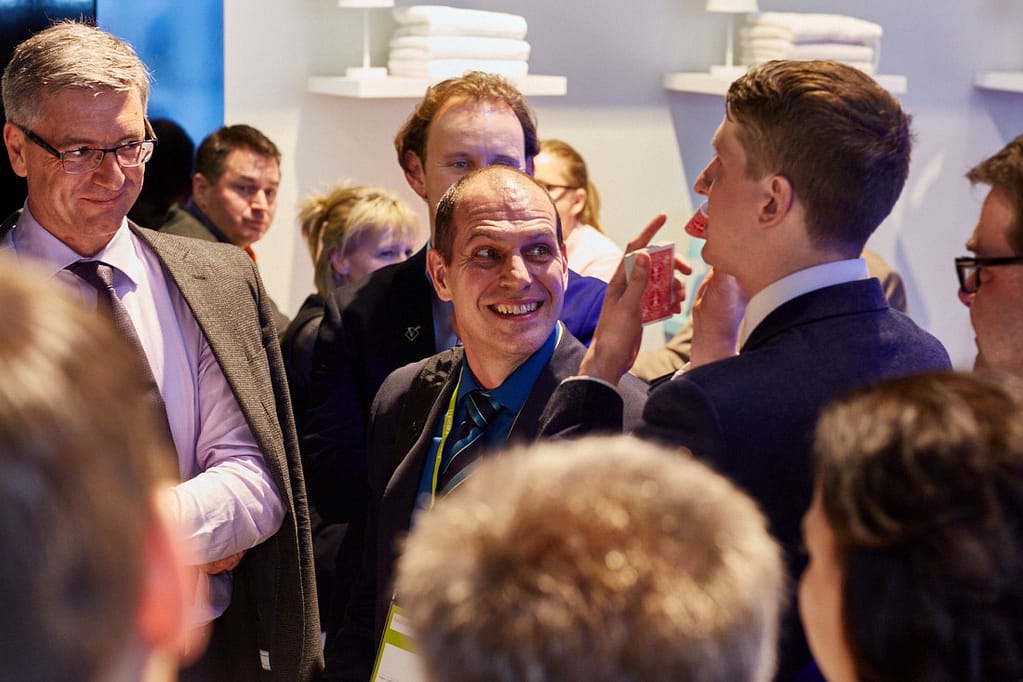 Corporate magician performing close-up magic at a business event in London.