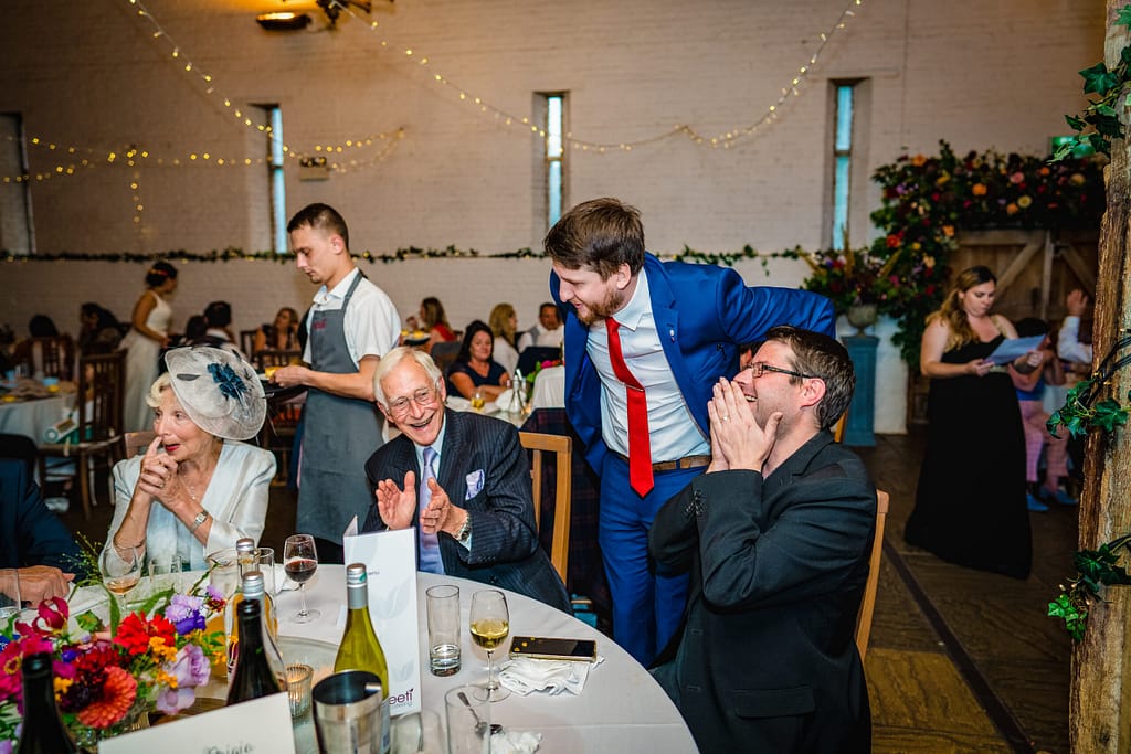 Close-up magician performing card magic at a wedding reception in Croydon.