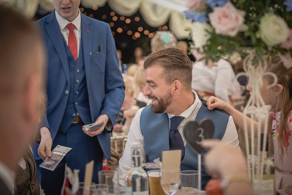 Close-up magician performing card magic at a wedding reception in Sevenoaks.