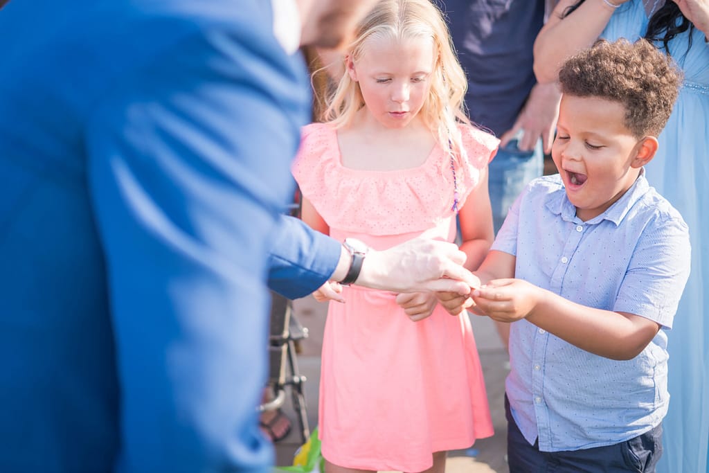 Guests enjoying interactive magic at a birthday celebration in Croydon.