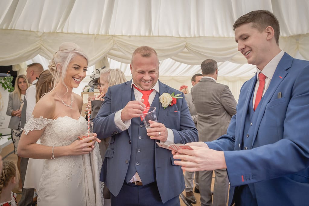 Close-up magician entertaining guests with card magic in Surrey.