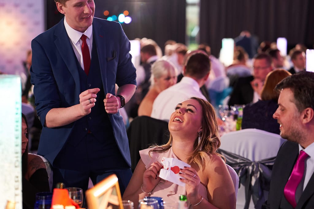 Magician Pete James performing close-up magic for guests in Canary Wharf.