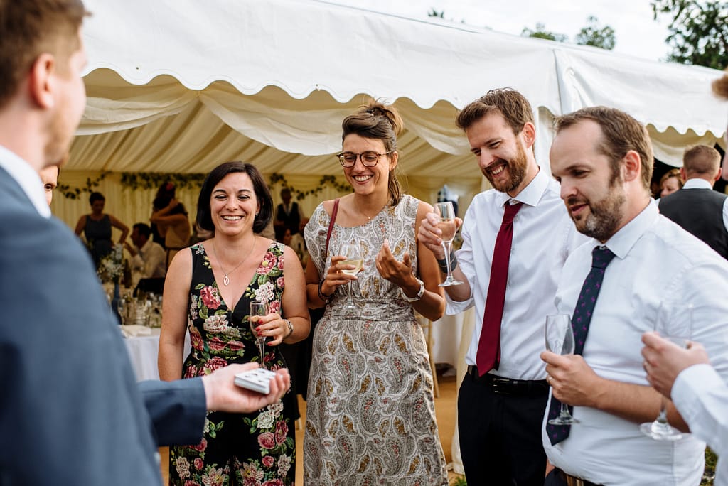 Close-up magician performing card magic at a wedding reception in Surrey.