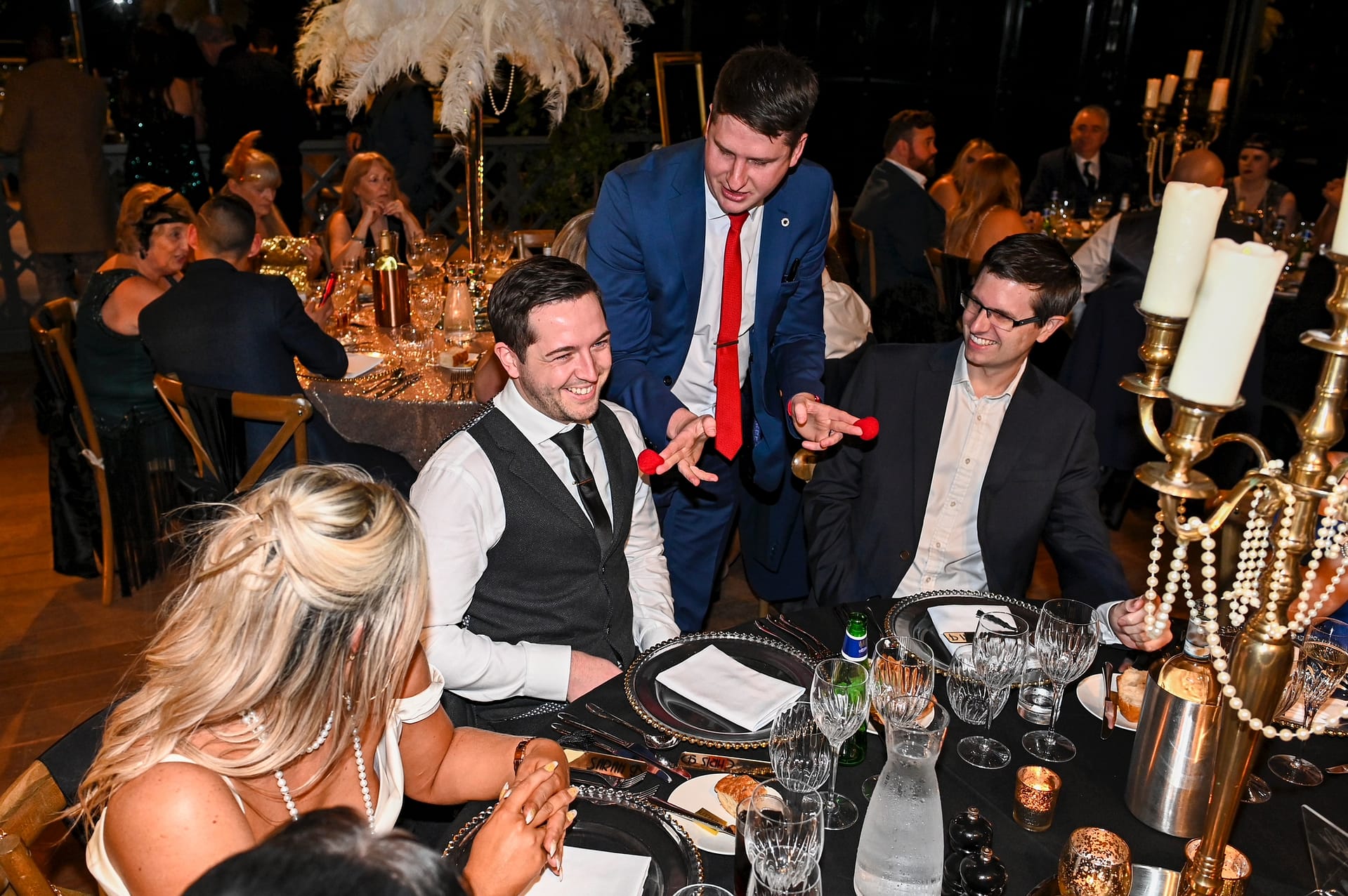 Professional magician engaging colleagues at a company event in Canary Wharf.