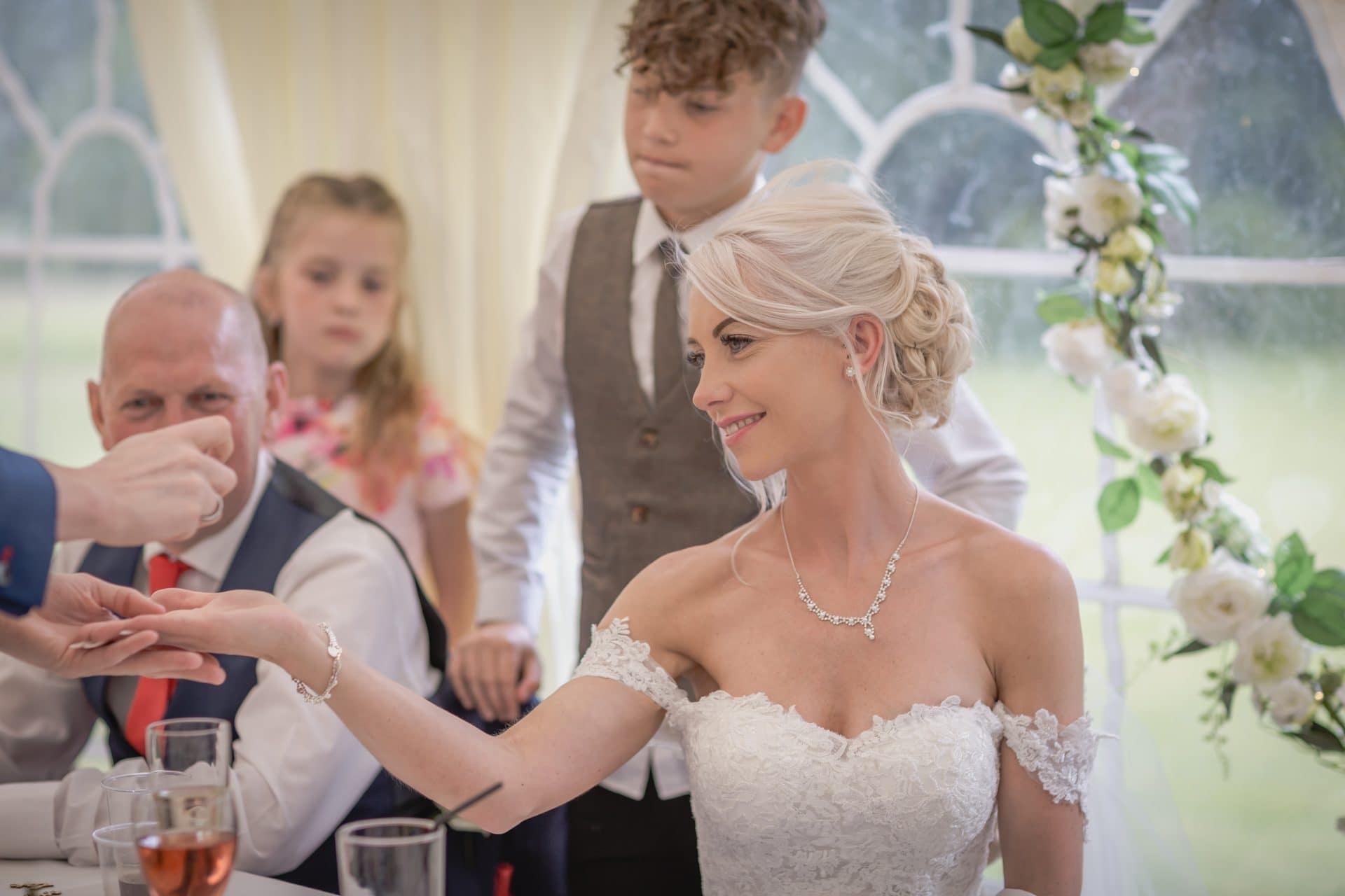 Wedding guests enjoying interactive close-up magic in Canary Wharf.